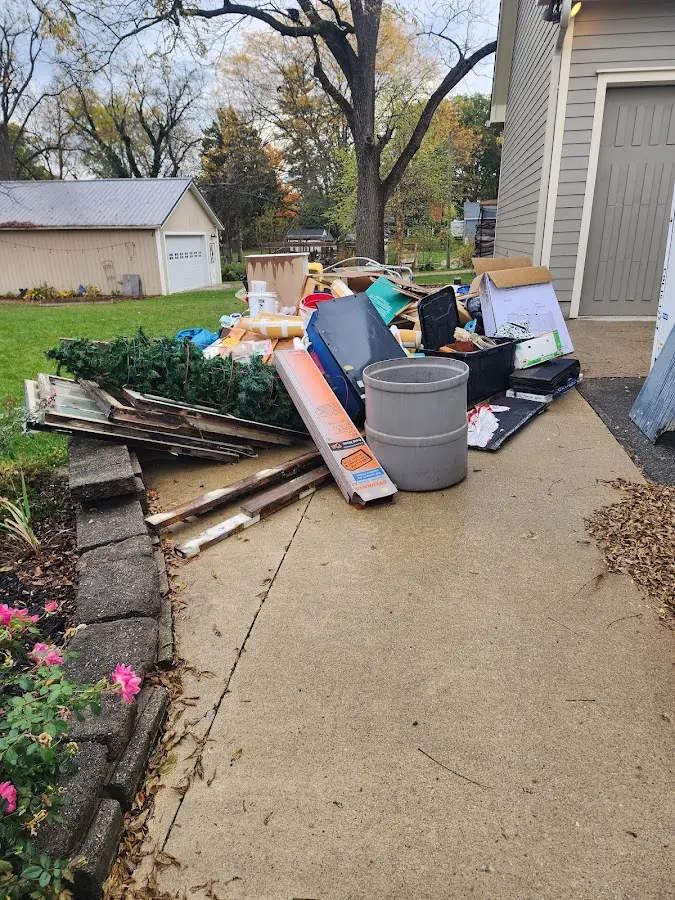 Dumpster being loaded with debris for 12 Yard Dumpster Rental in Gilroy